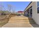 Multi-level wooden deck with outdoor grilling space that connects to the screened-in porch via stairs at 33 Song Breeze Cir, Angier, NC 27501