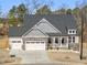 Charming two-story home with stone accents, a covered porch, and a two-car garage at 33 Song Breeze Cir, Angier, NC 27501