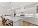 An open concept kitchen features white cabinets, quartz countertops, and stainless steel appliances at 33 Song Breeze Cir, Angier, NC 27501