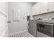 Well-equipped laundry room with modern washer, dryer, and storage cabinets at 33 Song Breeze Cir, Angier, NC 27501