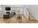 The living room and dining area have neutral paint, wood floors, and stairs to the second floor at 33 Song Breeze Cir, Angier, NC 27501