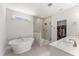 Bright main bathroom featuring glass enclosed shower, soaker tub and double vanity at 33 Song Breeze Cir, Angier, NC 27501