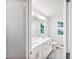 Bathroom with dual sinks, vanity, tile floor, toilet, and mirror with sconces at 3730 Mason Bluff Dr, Raleigh, NC 27616