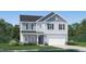 Charming two-story home with a manicured lawn and attached two car garage at 3730 Mason Bluff Dr, Raleigh, NC 27616