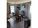 A dining room features laminate floors, gray walls, and a wood dining room table at 402 Todd Hill Dr, Wendell, NC 27591