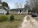 A well maintained single-story home with vinyl siding and a front yard with mature trees at 402 Todd Hill Dr, Wendell, NC 27591