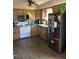 A kitchen features laminate floors, wooden cabinets, granite countertops, and stainless steel appliances at 402 Todd Hill Dr, Wendell, NC 27591