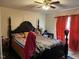 Main bedroom features a canopy bed, an orange curtain and a ceiling fan at 402 Todd Hill Dr, Wendell, NC 27591