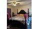 Main bedroom features a dark canopy bed, an interesting coverlet and ceiling fan at 402 Todd Hill Dr, Wendell, NC 27591