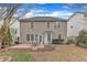 View of the home's exterior and backyard with patio at 413 Westfalen Dr, Cary, NC 27519