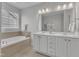 Bright bathroom features double vanity, soaking tub and great natural light at 413 Westfalen Dr, Cary, NC 27519