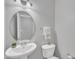 Elegant powder room with a pedestal sink, oval mirror, and neutral tones at 413 Westfalen Dr, Cary, NC 27519