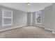 Bright carpeted bedroom with neutral walls and many windows at 413 Westfalen Dr, Cary, NC 27519