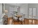 Bright dining room features a table with seating for six, window, and french doors at 413 Westfalen Dr, Cary, NC 27519
