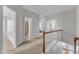 Upstairs hallway with access to multiple rooms, carpeted flooring, and wood railings at 413 Westfalen Dr, Cary, NC 27519