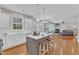 Open-concept kitchen with island seating, flowing into the living area with fireplace at 413 Westfalen Dr, Cary, NC 27519