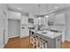 Modern kitchen with white cabinetry, stainless steel appliances, and an island with seating at 413 Westfalen Dr, Cary, NC 27519