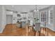 Open kitchen and dining area with stainless steel appliances and seating at the island at 413 Westfalen Dr, Cary, NC 27519