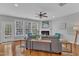 Cozy living room with fireplace, ceiling fan, hardwood floors, and lots of natural light at 413 Westfalen Dr, Cary, NC 27519