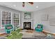 Bright living room features a fireplace with mantel and two armchairs at 413 Westfalen Dr, Cary, NC 27519