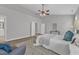 Stylish main bedroom featuring a ceiling fan and sitting area at 413 Westfalen Dr, Cary, NC 27519
