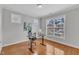 Well-lit office with a large window, hardwood floors, and grey walls at 413 Westfalen Dr, Cary, NC 27519