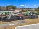 Community playground area with slides and climbing structures for residents, surrounded by lush landscaping and fencing at 413 Westfalen Dr, Cary, NC 27519