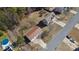Aerial view showcases home with detached garage, long driveway, and lush surroundings at 424 Crystal Spring Dr, Sanford, NC 27332