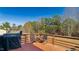 Outdoor deck featuring wood railing, patio set, and Traeger grill with scenic wooded views at 424 Crystal Spring Dr, Sanford, NC 27332