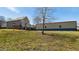 Expansive backyard featuring a large detached garage, partial fence, and grassy area at 424 Crystal Spring Dr, Sanford, NC 27332