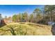 Large backyard with a trampoline, shed, and a mix of trees at 424 Crystal Spring Dr, Sanford, NC 27332