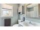 Bright bathroom with a gray vanity, toilet, a large mirror and natural light at 424 Crystal Spring Dr, Sanford, NC 27332