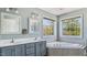 Bathroom with double sinks, corner tub, and natural light from two large windows at 424 Crystal Spring Dr, Sanford, NC 27332