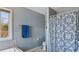 Bathroom features a blue towel, patterned shower curtain, and window with natural light at 424 Crystal Spring Dr, Sanford, NC 27332