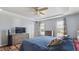 Comfortable bedroom featuring a tray ceiling, two windows, and matching dressers at 424 Crystal Spring Dr, Sanford, NC 27332