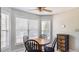 Bright breakfast nook with tile floors, three windows and a round wooden table with chairs at 424 Crystal Spring Dr, Sanford, NC 27332