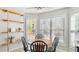 Bright dining area features a round table, four chairs, and built-in shelving at 424 Crystal Spring Dr, Sanford, NC 27332