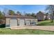 Large detached garage with three bays and gravel driveway behind the house at 424 Crystal Spring Dr, Sanford, NC 27332
