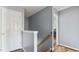 Upstairs hallway with wood floors, gray walls, and a white door at 424 Crystal Spring Dr, Sanford, NC 27332