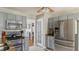 Well-lit kitchen boasts stainless steel appliances, gray cabinetry, and tile flooring at 424 Crystal Spring Dr, Sanford, NC 27332