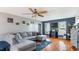 Spacious living room with hardwood floors, a ceiling fan and comfortable gray sectional at 424 Crystal Spring Dr, Sanford, NC 27332