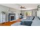 Bright living room with hardwood floors, fireplace, ceiling fan and sliding glass doors to the deck at 424 Crystal Spring Dr, Sanford, NC 27332