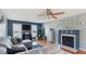 Cozy living room with hardwood floors, a fireplace, a ceiling fan and comfortable gray sectional at 424 Crystal Spring Dr, Sanford, NC 27332