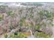An aerial view reveals a home nestled among mature trees, offering privacy and seclusion at 48 Margaret Pl, Chapel Hill, NC 27516