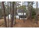 Backyard view of home featuring a screened porch surrounded by trees providing seclusion at 48 Margaret Pl, Chapel Hill, NC 27516