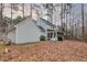 The home features a screened-in porch and large backyard nestled amongst mature trees at 48 Margaret Pl, Chapel Hill, NC 27516