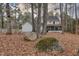 Backyard view of a two-story house with a screened-in porch surrounded by mature trees at 48 Margaret Pl, Chapel Hill, NC 27516