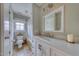 Bright bathroom featuring tile floors, modern vanity, bathtub with shower, and a window with wooded view at 48 Margaret Pl, Chapel Hill, NC 27516
