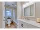 Bright bathroom featuring tile floors, modern vanity, bathtub with shower, and a window with wooded view at 48 Margaret Pl, Chapel Hill, NC 27516