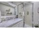 Fresh bathroom with marble countertop vanity, stylish mirror, and modern glass shower at 48 Margaret Pl, Chapel Hill, NC 27516